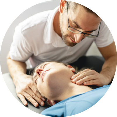Chiropractor treating patient neck on table