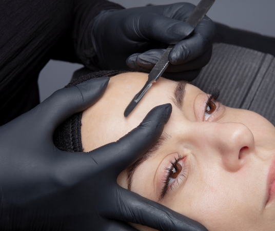 Woman receiving dermaplaning treatment