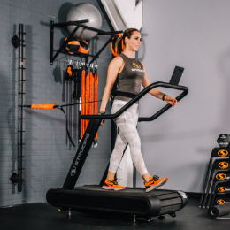 Woman walking on treadmill with spine strap attached to back