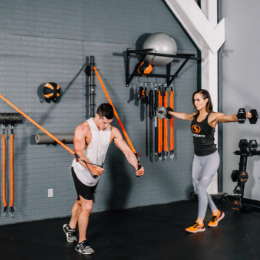 Man and woman in gym using Stroops products