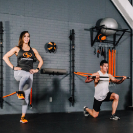 Woman and man in gym using Stroops products
