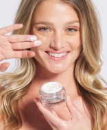 Woman holding jar of Jan Marini product