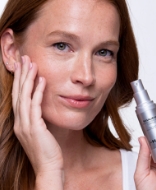 Woman holding Jan Marini skin care product