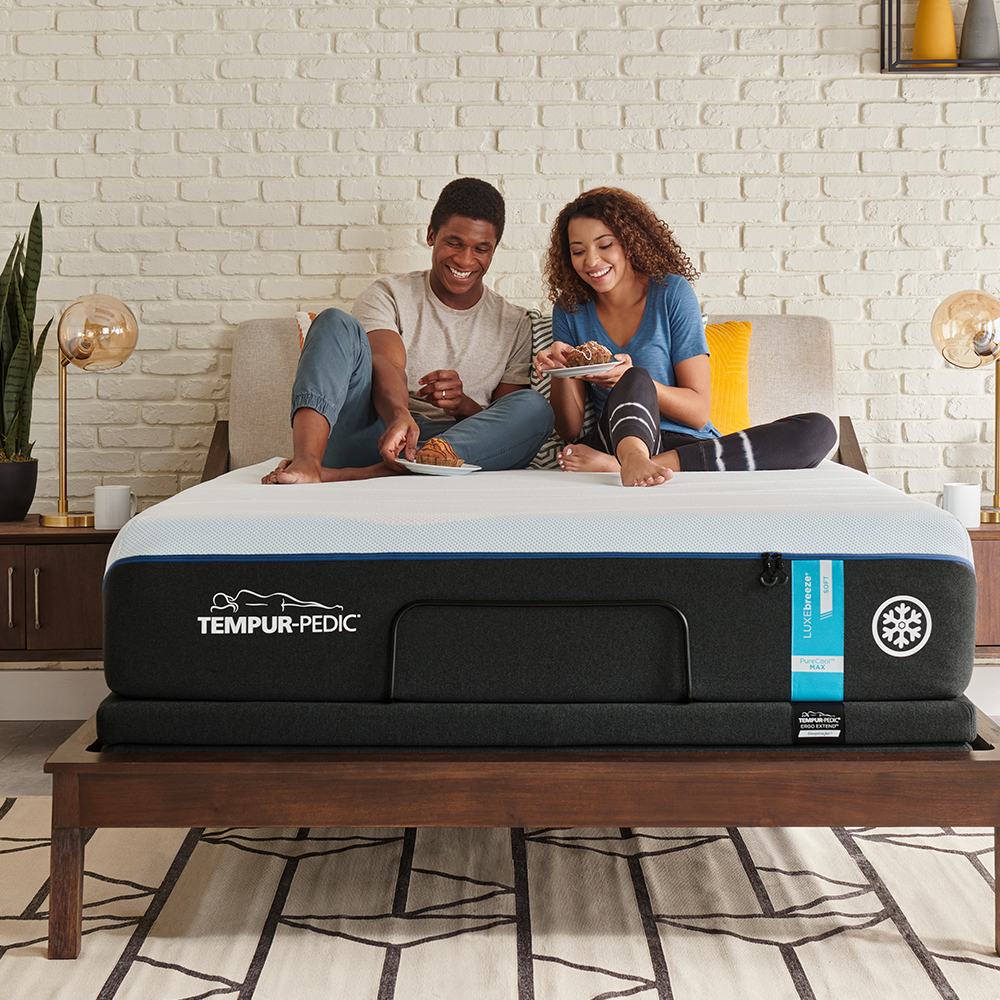 Couple laying on a TempurPedic mattress in bedroom